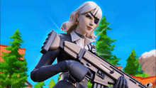 a woman in a suit is holding a gun in her hands .