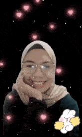 a woman wearing glasses and a hijab is surrounded by pink hearts and the words " semangat "