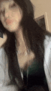 a blurry picture of a woman taking a selfie with her phone .