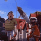 a group of cartoon characters are standing next to each other in front of a house .