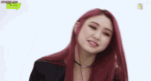 a close up of a woman with red hair making a face .