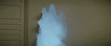 a smoke filled room with a silhouette of a person in the corner