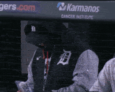a man wearing a black jacket with the letter b on it