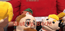 a group of stuffed animals are sitting in front of a red couch with the words shut up bitch written in red