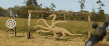 a statue of a snake is being shot at a target