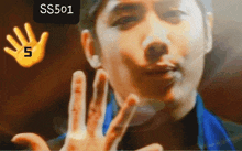 a man 's face is behind a hand that has the number 5 on it