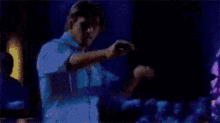 a man and a woman are dancing together in a dark room .