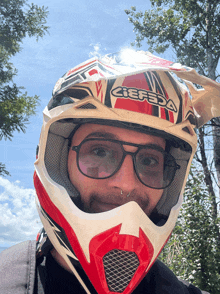 a man wearing a red and white helmet that says acerbis on it
