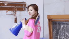 a girl wearing a pink shirt that says twice on it
