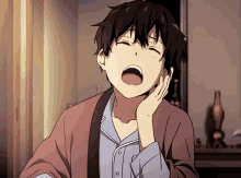 a boy with his mouth open and his hand on his chin