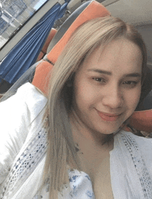 a woman with blonde hair is sitting in a car