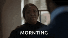 a woman is crying while talking to a man and the word morning is visible .