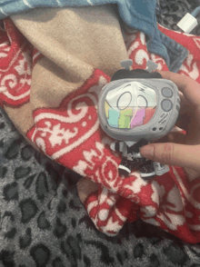a person holding a stuffed toy that looks like a television
