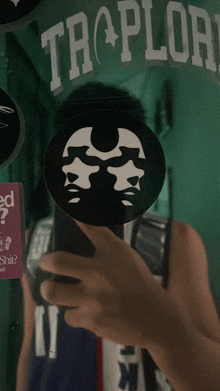 a person taking a picture of themselves in front of a sign that says tropilori