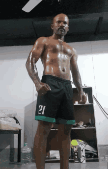 a shirtless man wearing shorts with the number 21 on the side