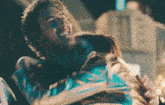 a man and a woman are hugging each other and the man is smiling