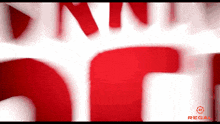 a blurred image of a red and white logo for regal