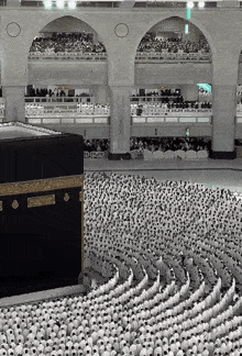 a large crowd of people are gathered in front of a kaaba