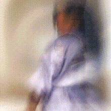 a blurry picture of a person in a purple shirt