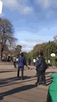 a group of people playing basketball on a court
