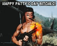 a man is holding a gun and smoking a cigar with the words happy patty 's day bitches below him