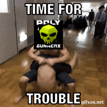two men are wrestling in a hallway with the words time for trouble below them