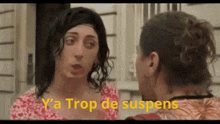 two women are talking to each other and the words trop de suspens are visible