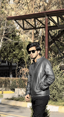 a man wearing sunglasses and a leather jacket