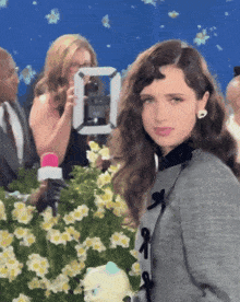 a woman is standing in front of a camera with the number 10 on it