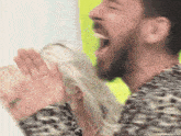 a man with a beard is screaming with his mouth open