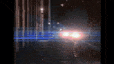a blurry picture of a car driving down a dark street at night