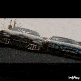 two race cars are racing on a track with a watermark that says imgplay at the bottom