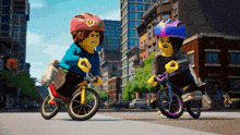 two lego characters are riding bicycles in a city