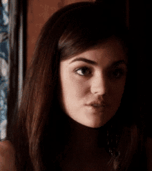 a close up of a woman 's face in a dark room .