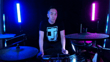 a man wearing a black t-shirt with the letter j on it