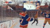 a hockey player wearing a number 7 jersey holds a hockey stick