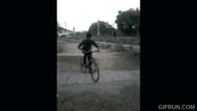 a blurry picture of a person riding a bike with gifrun.com written on the bottom
