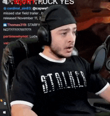 a man wearing headphones and a t-shirt that says still