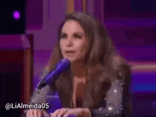 a woman is sitting in front of a microphone .