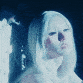 a close up of a woman 's face with white hair and blue eyes
