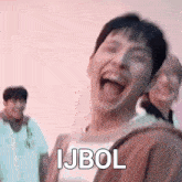 a man is making a funny face with his tongue out and the words ijbol written on his face .