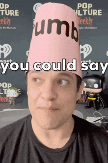 a man wearing a pink hat that says " you could say " on it
