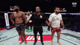 a referee stands between two fighters in a ufc ring sponsored by webster.com