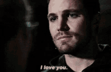 a close up of a man 's face with the words `` i love you '' written on it .