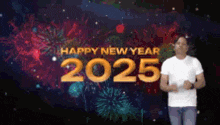 a man is standing in front of a fireworks display that says happy new year 2025 .