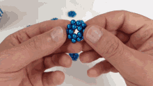 a person is holding a blue ball in their hands