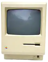an old apple computer monitor with a sticker on it