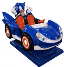 a statue of sonic the hedgehog riding a blue car .