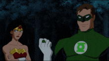 wonder woman and green lantern looking at a green glowing hand
