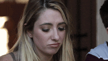 a close up of a woman 's face with a serious look on her face